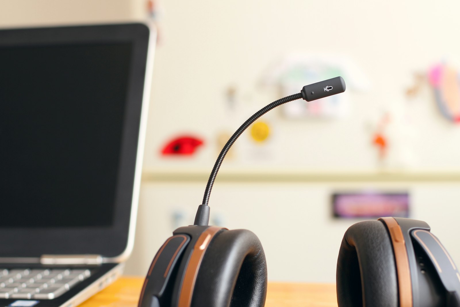 Headset resting next to a laptop